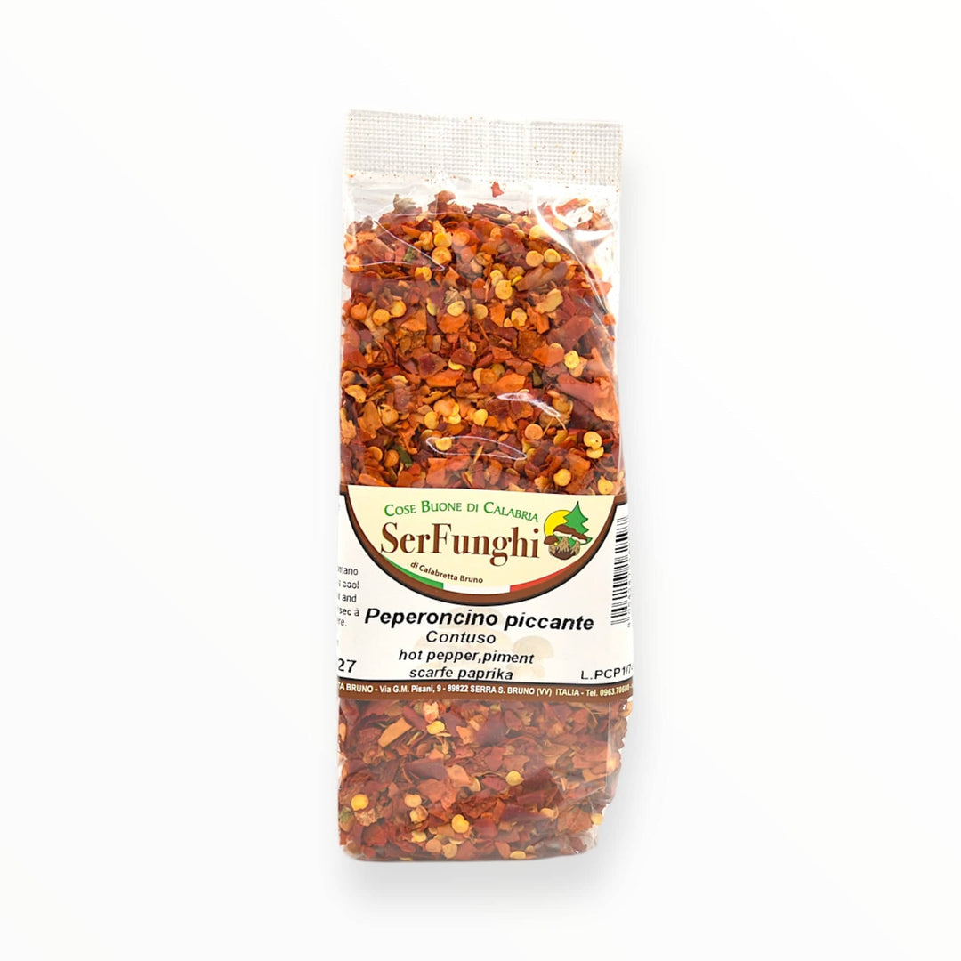 Bag of 100% natural Peperoncino piccante macinato a scaglie by SerFunghi, ideal for adding a vibrant, spicy flavor to dishes.